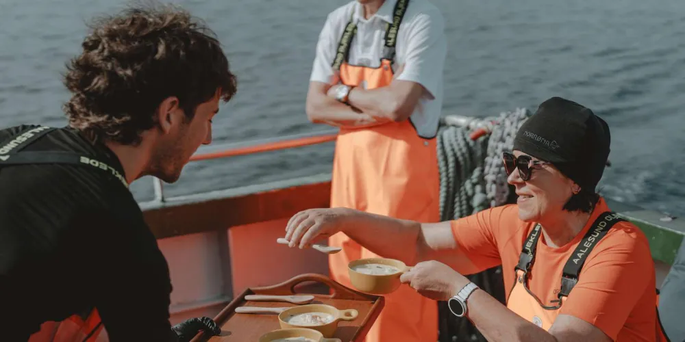 Guests enjoying fresh fish soup on deck after fishing